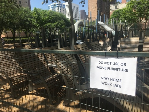 Discovery Green is still open in Houston, but a playground has been closed off, and visitors are not allowed to use the furniture under Harris County's new "Stay Home-Work Safe" order. Only a handful of visitors were at the park March 25. (Shawn Arrajj/Community Impact Newspaper)