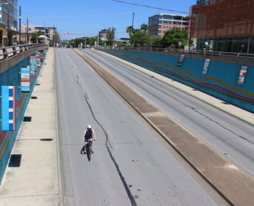 A bicyclist rides down Lamar Boulevard on March 25. (Christopher Neely/Community Impact Newspaper)