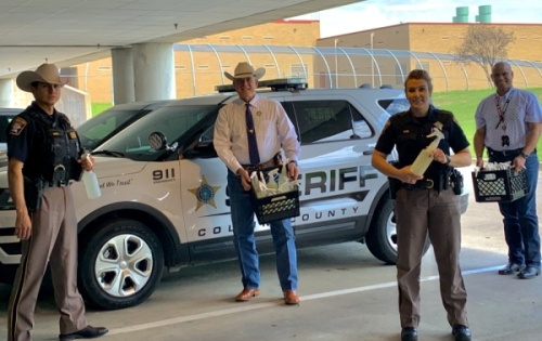 Deputy Nick Noel, Sheriff Jim Skinner, Sgt. Jessica Pond and Asst. Chief Anthony Carter of the Collin County Sheriff’s Office show off the hospital-grade disinfectant they received as part of the Facebook group created by The Cleaning Force. (Courtesy Collin County Sheriff’s Office)