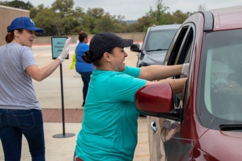 NBISD workers deliver meals to students at the Veramendi Elementary School meal pickup location March 17. (Courtesy New Braunfels ISD)