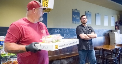 CraigO's Pizza & Pastaria owner Andrew Rincon (right), volunteer Mark Crowell (left) and a team of several other people helped feed dozens of at-risk families in the Lake Travis community April 2. (Courtesy Mason Culp)