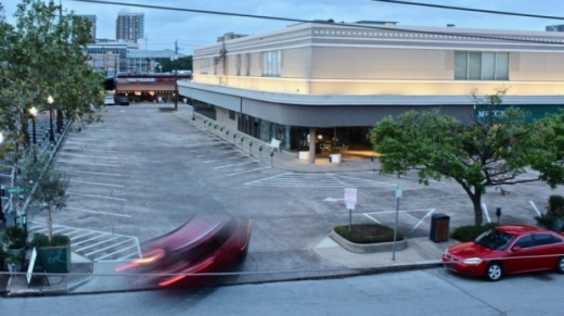 A car enters an empty parking lot at Rice Village on March 27. With social distancing measures in effect, small businesses have taken a hit. (Matt Dulin/Community Impact Newspaper)
