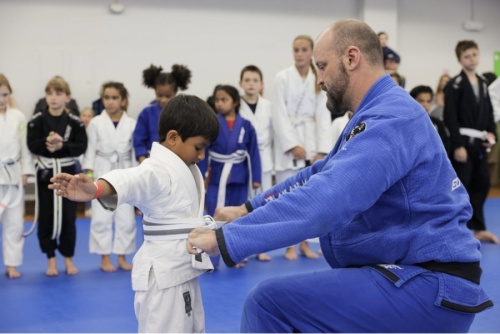 Josh Lanier, who has faught for Bellator, helps with children's Brazilian jiu-jitsu belt test at Elite MMA./Courtesy of Elite MMA