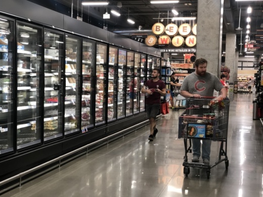 Shoppers in a Houston area store survey the products at H-E-B. (Nola Valente/Community Impact Newspaper)