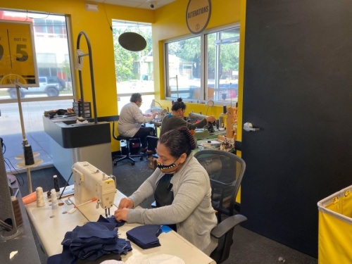 A photo of employees at ZIPS Dry Cleaning making masks