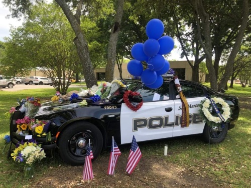 The scout car of the fallen police officer is parked in front of San Marcos City Hall. (Evelin Garcia/ Community Impact Newspaper)