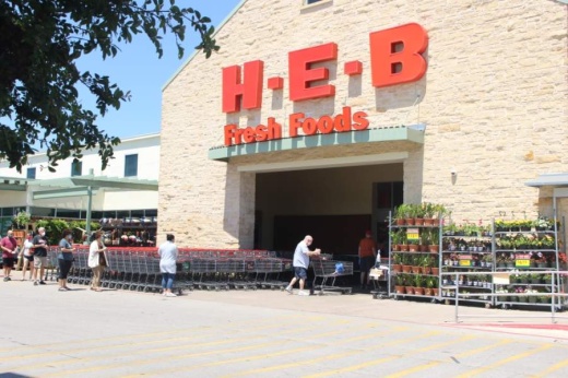 Southwest Austin residents wearing medical masks wait in line to enter the H-E-B on the corner of Brodie Lane and William Cannon Drive April 16. (Nicholas Cicale/Community Impact Newspaper)