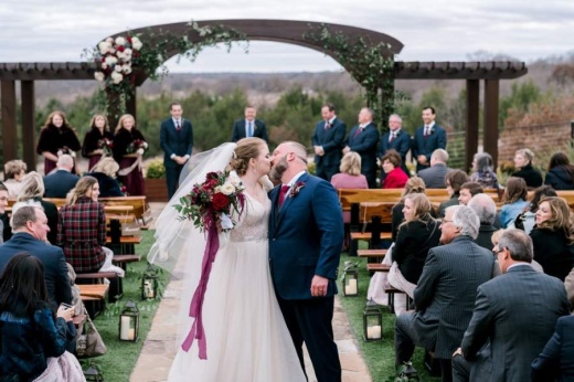 Rebecca and Jay kiss at their wedding last year at Stone Crest Venue in McKinney. (Courtesy Catie Ann Photography)