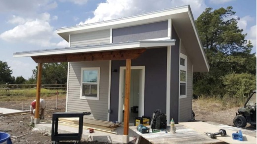 A photo of a tiny house with a roof donated by Austin Roofing and Construction