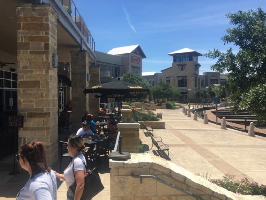 Diners sit outside at World of Beer at the Boardwalk at Towne Lake in Cypress, which reopened for dine-in service with limited capacity May 1. (Shawn Arrajj/Community Impact Newspaper)