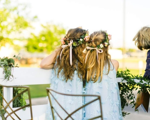 two flower girls, from behind