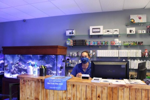 On May 1, the first day of loosened retail and restaurant restrictions imposed due to the COVID-19 pandemic, owner John Duncan sports a protective facemask inside of Coral Fish and Beyond, located at 2041 Rufe Snow Drive, Ste. 303, Keller. (Ian Pribanic/Community Impact Newspaper)