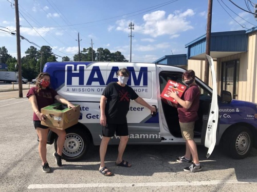 The Costello family loads food packs into a Humble Area Assistance Ministries van for distribution. (Courtesy Humble Area Assistance Ministries)