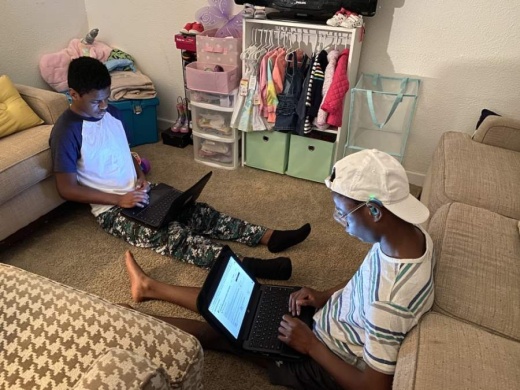 From left: Malachi and Emmanuel Lloyd, who are enrolled in the special education program at JJ Pearce High School, do their schoolwork online. (Courtesy Jacquelyn Lloyd)