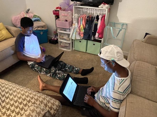 From left: Malachi and Emmanuel Lloyd, who are enrolled in the special education program at JJ Pearce High School, do their schoolwork online. (Courtesy Jacquelyn Lloyd)
