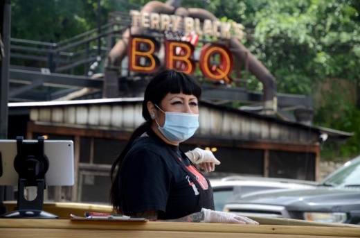 An employee at Terry Black's BBQ in South Austin wears a protective face covering during the restaurant's first day open on May 1. (John Cox/Community Impact Newspaper) 