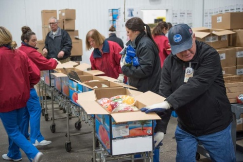 Volunteers pack boxes of food at the food bank. (Photo by Montgomery County Food Bank)