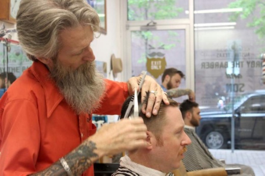 Kirby Schimmels Sr. cuts hair at his downtown barbershop in 2019. When Kirby the Barber reopens May 11, he will cut hair out of a new shop at his Hyde Park home, while his son, Kirby Schimmels Jr., will work downtown. (Jack Flagler/Community Impact Newspaper)