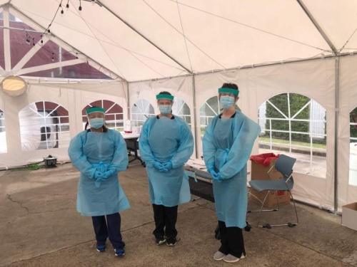 Three Legacy Community Health Services Inc. staff members stand in a COVID-19 testing tent. The health care center is receiving a $2 million federal grant to expand its testing capabilities. (Courtesy Legacy Community Health Services Inc.)