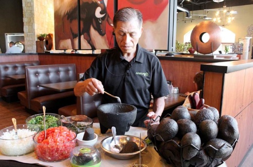 Onesimo Alonso prepares the restaurant's signature tableside guacamole. (Abigal Allen/Community Impact Newspaper)