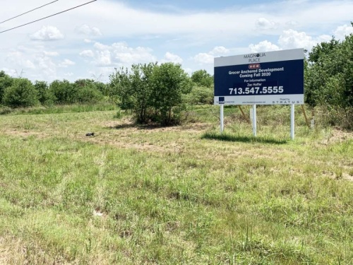 The city of Magnolia's planned H-E-B has been put on hold due to the coronavirus pandemic. It was previously slated to debut this fall, according to the sign posted at the property in 2019. (Kara McIntyre/Community Impact Newspaper)