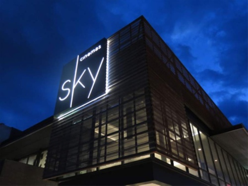 A photo of a sign on a building that reads "Sky Cinemas"