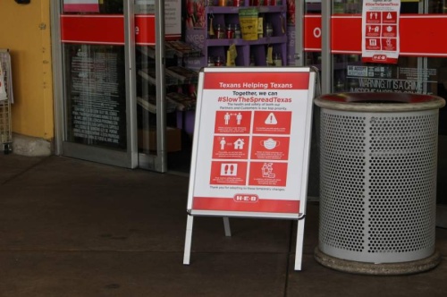 Signage at a Katy-area HEB recommends shoppers practice social distancing guidelines. (Nola Z. Valente/Community Impact Newspaper)