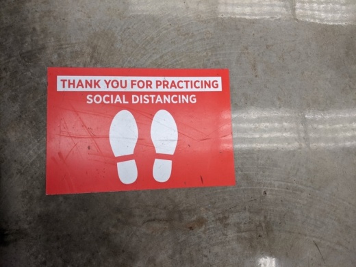 Floor decals at H-E-B encourage social distancing. (Jen Para/Community Impact Newspaper)