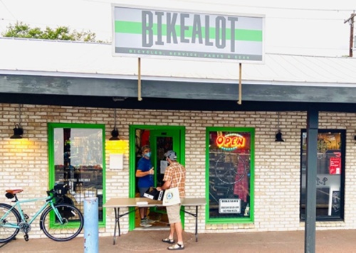 A photo of a man making a curbside purchase at Bikealot