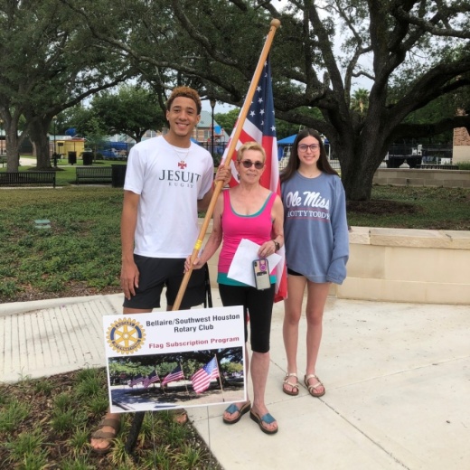 Preparation for the graduation celebration includes moving flags originally used to decorate around Bellaire for Memorial Day along the procession route. Jared Robinson, graduate of Strake Jesuit, Bellaire city councilwoman Michael Fife, and Raegan Roylance, graduate of The Tenney School helped move these flags ahead of the event. (Courtesy Deborah Roylance)