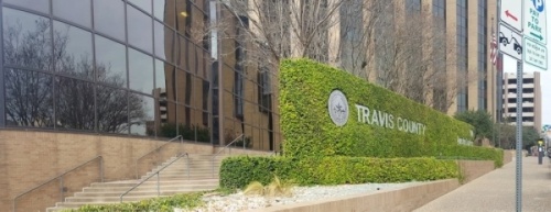 A photo of the Travis County headquarters sign