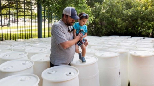 The syrup drums being repurposed into rain barrels were donated from Coca-Cola. (Courtesy Galveston Bay Foundation)