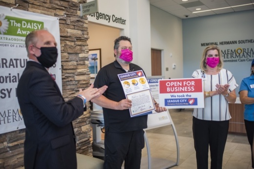 Scott Livingston (left), the League City's economic development director and a League City Turnaround Taskforce member, stands with Memorial Hermann employees who took the city's pledge to be safe during the coronavirus pandemic. (Courtesy city of League City)