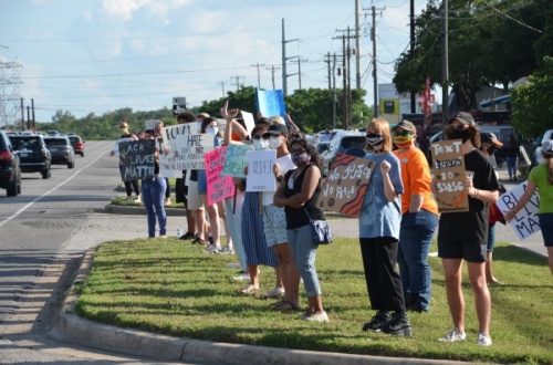 Peaceful protestors stand on the corner of RM 2222 and RM 620 June 5. (Courtesy Chris Backus)