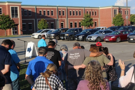 Members of the Magnolia community gathered to pray June 5 for unity amid unrest in the nation. Some gathered on the lawn in front of Magnolia High School while others stayed in their vehicles, listening in via an FM transmitter. (Dylan Sherman/Community Impact Newspaper)