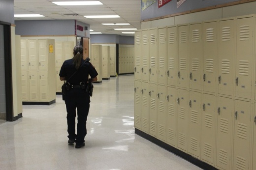 An Austin ISD Police Department officer walks that halls of Northeast Early College High School. (Nicholas Cicale/Community Impact Newspaper)