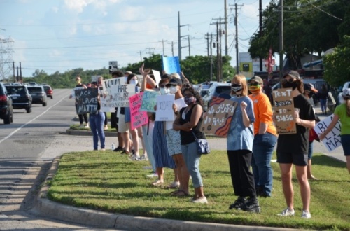 Residents have organized protests through the Lake Travis area. Peaceful protestors stood on the corner of RM 2222 and RM 620 on June 5. (Courtesy Chris Backus)