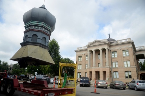 The onion dome on top of the Old Masonic Lodge Building, now Gumbo's North, was removed the morning of June 18. A new but identical dome will replace the old one after repairs to the building's roof are complete. (John Cox/Community Impact Newspaper)