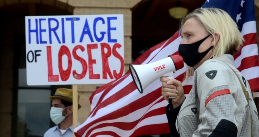 Georgetown resident Lina Terrell, of the Northern Williamson County Democrats, speaks to a group of about 25 people who want the statue of a Confederate soldier removed from the grounds of the Williamson County Courthouse. (John Cox/Community Impact Newspaper)