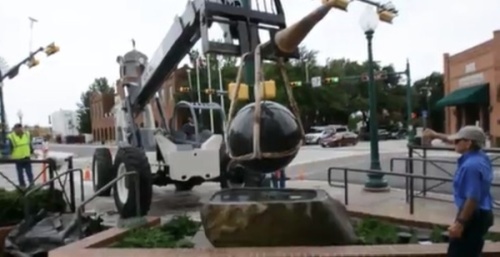 Crane holds granite sphere