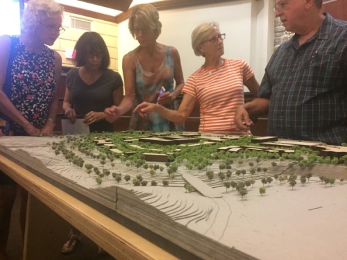 Residents examine a model of The Village at Spanish Oaks during an August 2018 Bee Cave City Council meeting. (Brian Rash/Community Impact Newspaper)