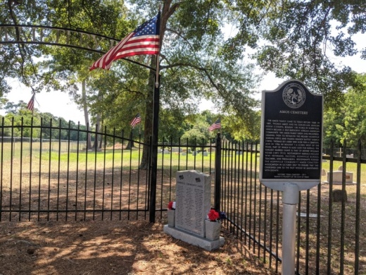 A historical marker rests at Amos Cemetery East, recognizing the African American cemetery. (Anna Lotz/Community Impact Newspaper)