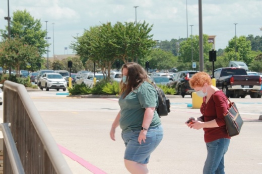 Residents walk through a shopping center in north Conroe wearing masks before Gov. Greg Abbott issued his statewide mask order. (Andy Li/Community Impact Newspaper)