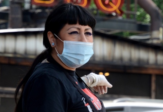 An employee at Terry Black's Barbecue in Austin works in a mask May 1. (John Cox/Community Impact Newspaper)