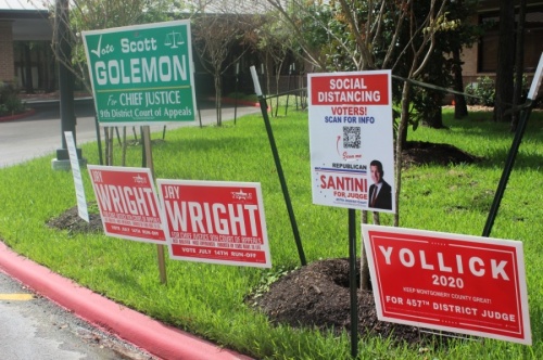 Several candidates' campaign signs were set up outside the South County Community Center in The Woodlands during early voting for the July 14 runoff election. (Ben Thompson/Community Impact Newspaper)