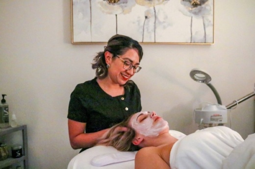 Esthetician Melissa Reyes gives a client a facial treatment. (Courtesy Trox Photography)