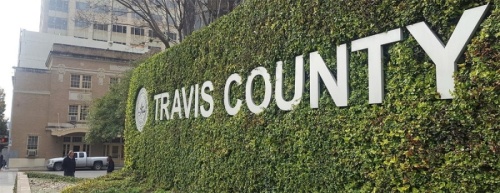 A phtoto of a sign that says "Travis County"