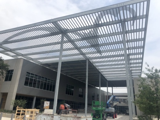 The canopy overlooking the entrance to Austin Community College’s under-construction campus features a Riverbat logo. (Jack Flagler/Community Impact Newspaper) 