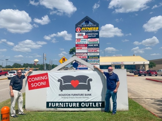 Hal Lynde, chairman of the Houston Furniture Bank board of directors (right) and Vice Chairman Larry Cress stand near the nonprofit's new sign at the Woodwinds Center in Spring. (Courtesy Houston Furniture Bank)