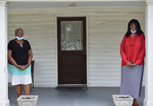 Laverne Holland (left), the great, great, great granddaughter of Harvey McLemore, stands with Alma McLemore, current president of the African American Heritage Society, on the porch of the historic McLemore House in Franklin. (Alex Hosey/Community Impact Newspaper)